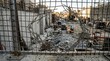 © Nana - Ripped Wire Fence Overlooking a Chaotic Construction Site with Heavy Machinery and Debris