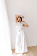 © Tania Cervian/Stocksy - Woman n white lace and wide-leg pants