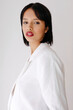 © Tania Cervian/Stocksy - Woman posing in white blazer with red lipstick