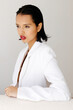 © Tania Cervian/Stocksy - Woman posing in white blazer with red lips
