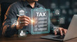 © Anjana444 - Businessman filling online tax return form on laptop with digital financial icons