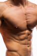 © skeronov - An athletically built man with a prominent torso and well-developed muscles is preparing for bodybuilding competitions. perfect abs and pectoral muscles with a minimum percentage of subcutaneous fat