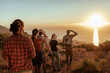 © Marko Geber - Group of hikers watching ocean sunset on coastal trail