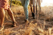 © Marko Geber - Group of hikers on dusty nature trail at sunset