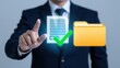 © CrazyJuke - Digital Document Management: A businessman in a dark suit uses a touchscreen to select a digital document, indicated by a green checkmark, alongside a yellow folder icon.