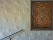 © ttrimmer - Ornate Wrought Iron Window Grate with a Bannister on Stone Wall.