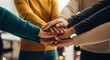 © Ariestia - Diverse Group of People Stacking Hands Together in Unity and Teamwork for Business Collaboration and Community Support