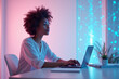 © YouraPechkin - Focused woman working on laptop in a vibrant, futuristic digital workspace