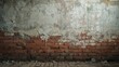 © AkuAku - Red brick wall surface with plaster decay and scattered debris on ground texture background