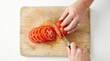 © Shiv - Person slicing ripe red tomato on wooden cutting board close-up top view preparing vegetable preparation culinary