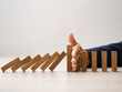 © morita - A human hand stopping a chain of falling dominoes, symbolizing crisis intervention and control.