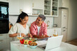 © Marko Geber - Smiling couple cooking dinner together at home kitchen