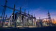 © Alexander - A professional photograph of a modern high-voltage substation and power distribution facility at twilight. The image highlights heavy industrial infrastructure, electrical engineer