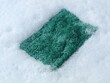 © Eka - Kitchen sponge floating in rich white soap foam and bubbles. Close-up background of cleaning process with detergent, shampoo, or soap suds, representing hygiene, housework, and sanitizing