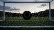 © Sheraz - Photorealistic and highly detailed silhouette of a classic soccer ball resting perfectly inside a clean white goal net, illustrating a successful score and victory in a competitive sport match.