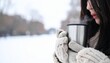 © Agus Ismanto - Woman holding steaming metal mug in winter snow