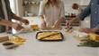 © QuoDesign - Friends sharing cheese and crackers in a cozy kitchen
