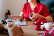 © Dani Nahuel/Stocksy - Midwife holding educational breast model