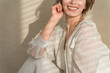 © buritora - A woman standing by a window bathed in the setting sun (model, fashion, light, shadow)