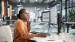 © Andrey Popov - Young African Woman Using Enterprise Software On Laptop