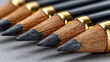 © Jurrat - Professional cosmetic eyeliner pencils arranged in a neat row for elegant makeup application and beauty styling close up macro shot with gold accents