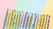 © Tayyab - Handmade colorful friendship bracelets arranged in rainbow pattern on light background