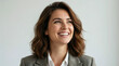 © jack - A smiling woman in a business blazer looking upward with a confident and optimistic expression against a neutral background