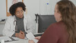 © Krakenimages.com - Woman patient receives paperwork from doctor with stethoscope at clinic building reception desk; empathy guidance.