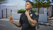 © Krakenimages.com - Police officer man holding donut, badge visible, hand on throat for choking on a street; duty hunger distress.
