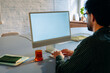 © DZ FILM/Stocksy - A man uses a computer with a white screen