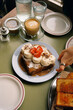 © Adrian Rodd/Stocksy - Modern Café Breakfast with French Toast and Specialty Coffee