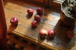 © Anna Artemenko/Stocksy - red curtain, apples and window light