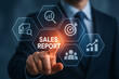 © Tanu - A businessman interacting with a digital sales report interface displaying key performance indicators
