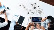 © InfiniteFlow - A dynamic business meeting featuring professionals analyzing data on laptops and tablets in a modern office, showcasing collaboration and technology. Raster