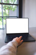 © Farknot Architect - Vertical mockup image of a woman working on laptop computer with blank white desktop screen