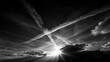 © Nick Freund - Kondensstreifen kreuzen sich kreuzförmig am dramatischen Schwarz-Weiß-Himmel mit Sonnenstrahlen