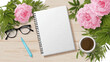 © Bagus Syah - Workspace with pink hydrangea flowers notebook glasses pen and coffee on wooden table