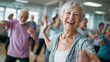© Harry - Joyful senior woman with gray hair laughing while participating in a vibrant indoor dance fitness class with other people