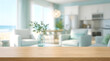 © Stocknetic Pro - Empty wood table top surface with blurred beach house kitchen living room interior background for product mockup display