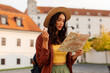 © Home-stock - Surprised woman looking at map while exploring historic site