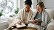 © mashimara - Two women writing in journals while wrapped in cozy blankets on a snowy day
