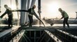 © salome - Construction Workers Pouring Concrete At Sunrise With Cityscape Background