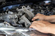 © NongAsimo - Close up mechanic holding worn engine mount part while inspecting car engine bay, Replacing damaged automotive components according to service schedule, Vehicle maintenance, Safety check optimal