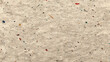 © pjjaruwan - Recycled paper texture speckled fibers muted tone natural handmade paper with colorful pulp flecks and visible fibers creating rustic textured background with warm neutral color and subtle