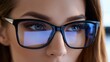 © Mariia - Close-up portrait of a woman wearing eyeglasses with screen reflections. Vision care concept related to eye protection, digital devices, optical health and blue light filtering