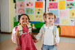 © AresStudio Belen y Carlos/Stocksy - Diverse little girls holding hands going to kindergarten