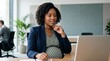 © Eve - Pregnant African American business woman working on laptop at modern office desk. Professional black female executive managing remote project during pregnancy for diversity workforce concept.