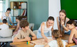 © JackF - Group of teens playing board game. Teenagers have fun during meetings and gatherings, enthusiastically and excitedly fulfill conditions of game