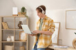 © Pixel-Shot - Teenage boy with laptop and headphones working online at home