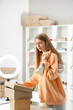 © Pixel-Shot - Female seller with sneakers in shoe shop